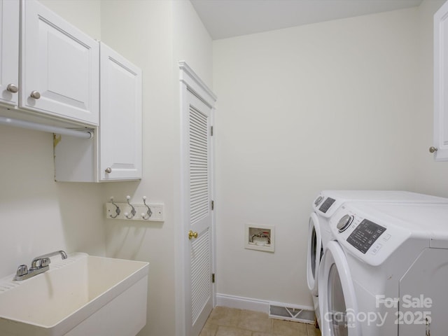 8508 Sandowne Ln, Huntersville, NC 28078 - laundry room with cabinet space, separate washer and dryer, and light tile patterned floors