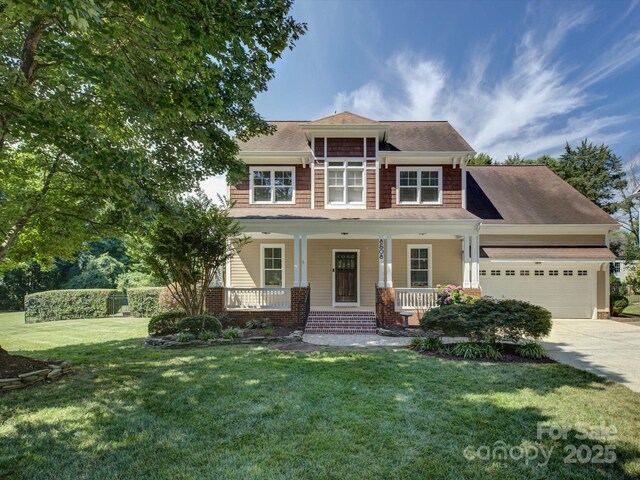 8508 Sandowne Ln, Huntersville, NC 28078 - view of front facade featuring a garage, concrete driveway, a front yard, a porch, and roof with shingles