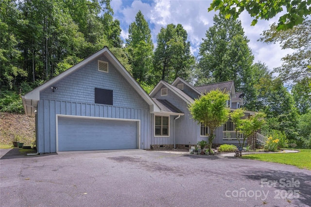 98 Choga Rdg, Whittier, NC 28789 - view of front of property with board and batten siding, driveway, and crawl space