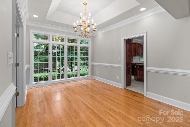 165 Futrell Lndg, New London, NC 28127 - spare room featuring a chandelier, light wood finished floors, a tray ceiling, ornamental molding, and recessed lighting
