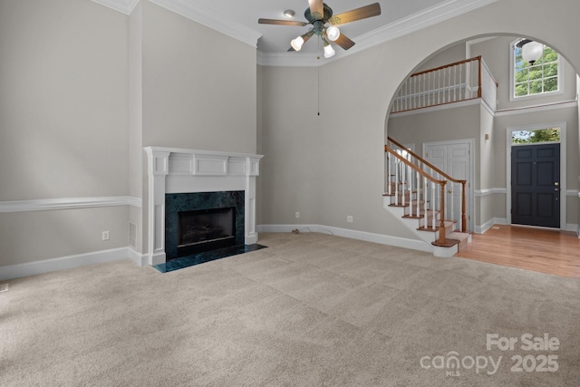 165 Futrell Lndg, New London, NC 28127 - unfurnished living room with carpet floors, ceiling fan, stairway, ornamental molding, and arched walkways