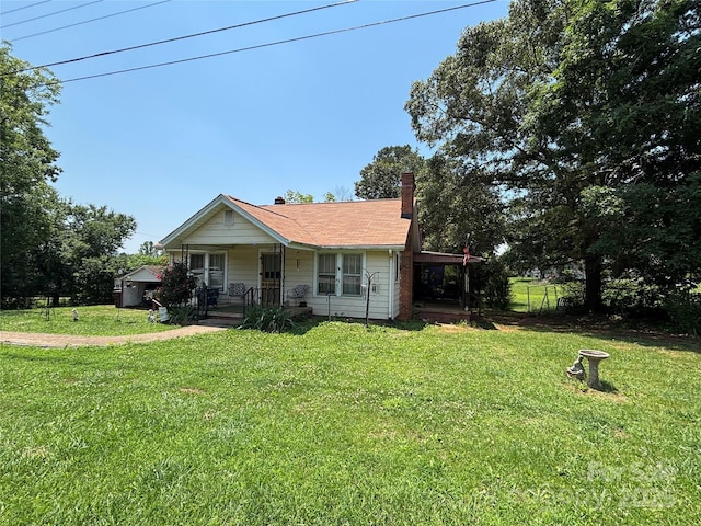 4059 10th Avenue Dr SW, Hickory, NC 28602 - view of front of house featuring a porch, a chimney, and a front lawn
