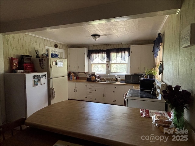 4059 10th Avenue Dr SW, Hickory, NC 28602 - kitchen featuring white appliances, white cabinetry, wallpapered walls, and ornamental molding