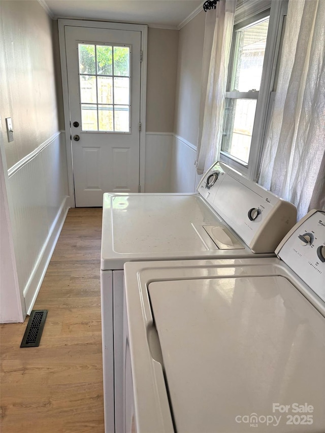 339 Mayflower Ave, Cramerton, NC 28032 - laundry area with washer and dryer, light wood-type flooring, crown molding, and a wainscoted wall