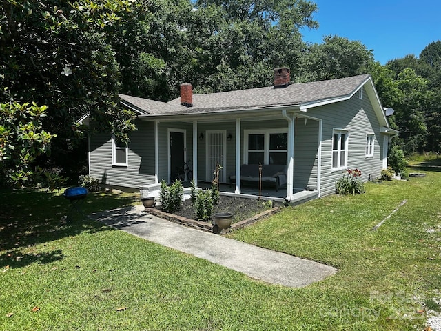 448 Belk St, Lancaster, SC 29720 - view of front of home featuring a chimney, a front lawn, covered porch, and roof with shingles
