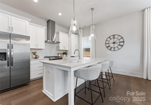 2600 Mason Cir Unit A, Charlotte, NC 28205 - kitchen featuring stainless steel appliances, wall chimney exhaust hood, dark wood-style flooring, a breakfast bar area, and recessed lighting