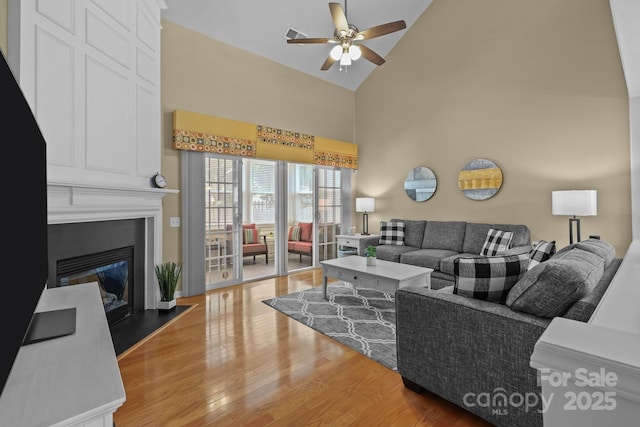 5238 Prosperity View Dr, Charlotte, NC 28269 - living room with high vaulted ceiling, wood finished floors, ceiling fan, and a large fireplace