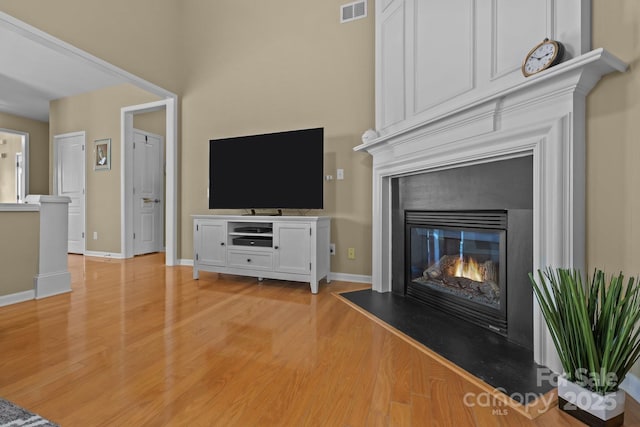5238 Prosperity View Dr, Charlotte, NC 28269 - unfurnished living room with a glass covered fireplace and light wood-style flooring
