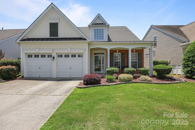 5238 Prosperity View Dr, Charlotte, NC 28269 - view of front of home featuring concrete driveway, a front yard, a standing seam roof, covered porch, and a garage