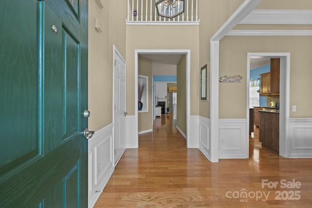 5238 Prosperity View Dr, Charlotte, NC 28269 - foyer entrance with a wainscoted wall, light wood finished floors, and ornamental molding