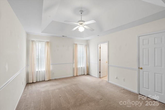 3114 Pine Pointe St, Matthews, NC 28104 - unfurnished bedroom with carpet, a tray ceiling, and a ceiling fan