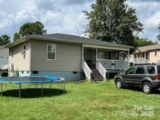 1545 Fairway Acres Dr, Lenoir, NC 28645 - rear view of house featuring a trampoline, a yard, covered porch, and stairs