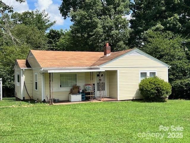 1545 Fairway Acres Dr, Lenoir, NC 28645 - rear view of property featuring a porch, a yard, and a chimney