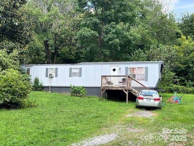 1545 Fairway Acres Dr, Lenoir, NC 28645 - manufactured / mobile home with a front lawn, a wooden deck, and a wooded view