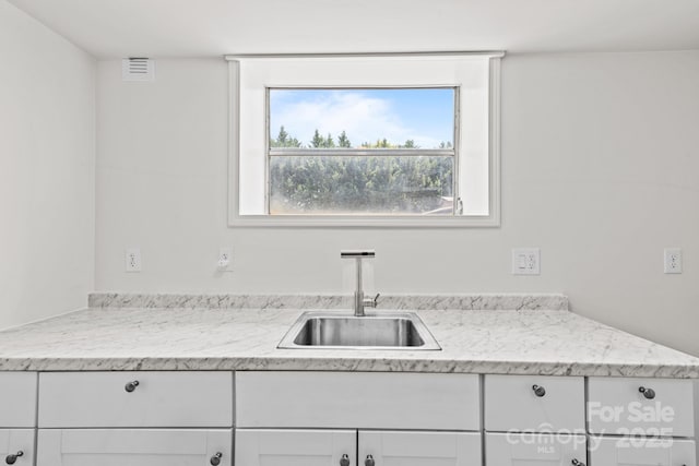 306 2nd Avenue Pl NE, Conover, NC 28613 - kitchen featuring white cabinets and light stone countertops