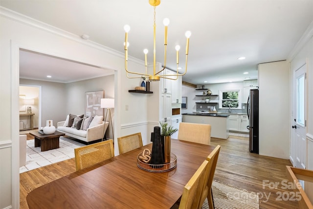 6150 Rocky Falls Rd, Charlotte, NC 28211 - dining area with light wood finished floors, ornamental molding, recessed lighting, and a chandelier