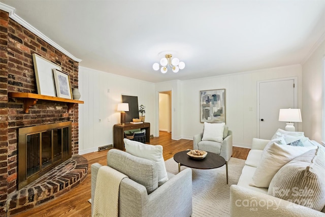 6150 Rocky Falls Rd, Charlotte, NC 28211 - living area with crown molding, wood finished floors, a brick fireplace, and a chandelier