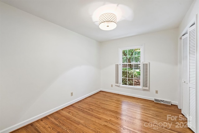 6150 Rocky Falls Rd, Charlotte, NC 28211 - unfurnished bedroom with light wood-style floors and a closet
