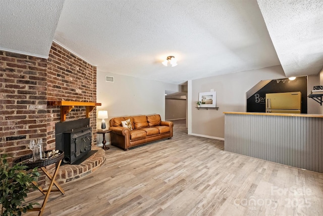 6150 Rocky Falls Rd, Charlotte, NC 28211 - living room featuring a textured ceiling, wood finished floors, and a wood stove