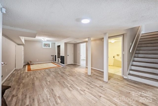 6150 Rocky Falls Rd, Charlotte, NC 28211 - finished below grade area with light wood-type flooring, a textured ceiling, and stairway