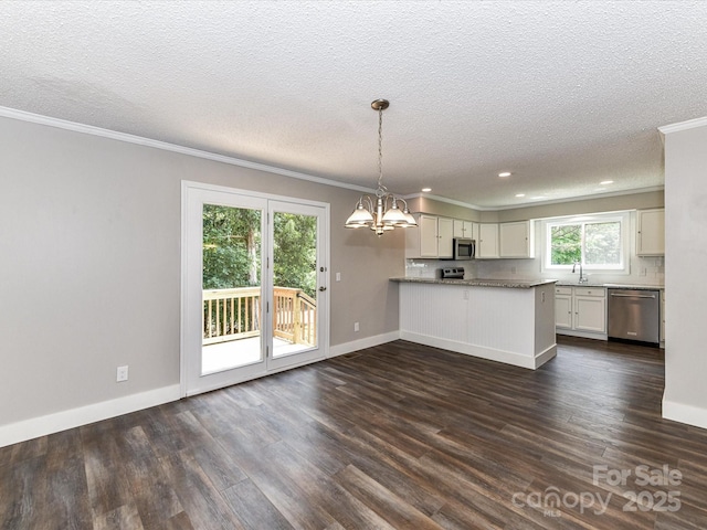 1117 Hidden Brook Ln, Clover, SC 29710 - kitchen with stainless steel appliances, crown molding, a chandelier, a peninsula, and dark wood-style floors