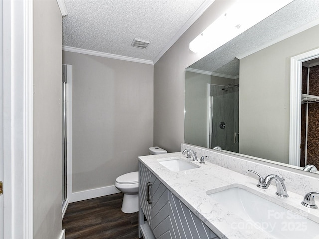 1117 Hidden Brook Ln, Clover, SC 29710 - full bathroom with a stall shower, wood finished floors, a textured ceiling, double vanity, and crown molding