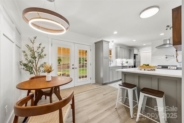 8438 Henry Harris Rd, Fort Mill, SC 29707 - kitchen featuring gray cabinetry, appliances with stainless steel finishes, light countertops, a kitchen breakfast bar, and recessed lighting