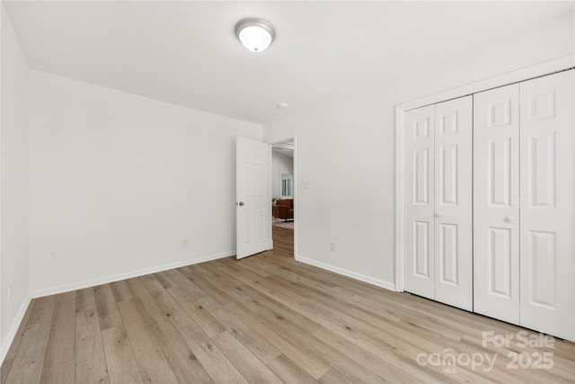 8438 Henry Harris Rd, Fort Mill, SC 29707 - unfurnished bedroom with light wood-type flooring and a closet