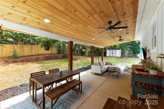 8438 Henry Harris Rd, Fort Mill, SC 29707 - fenced backyard featuring a storage unit, a patio area, an outdoor living space, outdoor dining area, and a ceiling fan