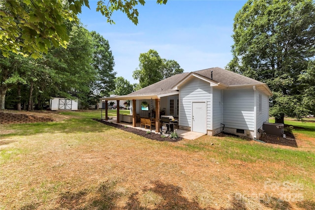 8438 Henry Harris Rd, Fort Mill, SC 29707 - view of side of property featuring a storage shed, a patio area, a yard, a shingled roof, and crawl space