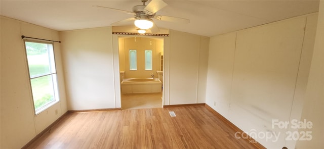 67 Brown Lynch Rd, Candler, NC 28715 - unfurnished room featuring wood finished floors, plenty of natural light, and ceiling fan