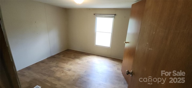 67 Brown Lynch Rd, Candler, NC 28715 - unfurnished room with healthy amount of natural light and wood finished floors