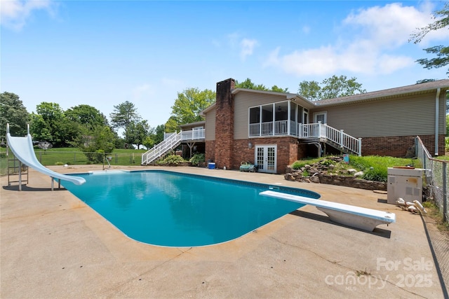 5563 Grace Chapel Rd, Hickory, NC 28601 - view of swimming pool with stairway, a diving board, a water slide, french doors, and a patio