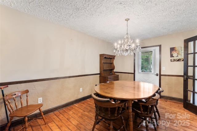 5563 Grace Chapel Rd, Hickory, NC 28601 - dining area featuring a textured ceiling, light wood-type flooring, and a chandelier