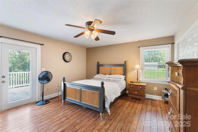 5563 Grace Chapel Rd, Hickory, NC 28601 - bedroom featuring access to exterior, a textured ceiling, wood finished floors, and a ceiling fan