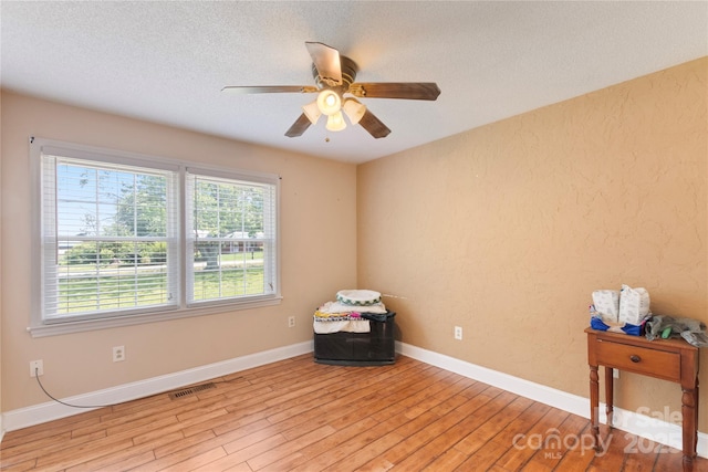 5563 Grace Chapel Rd, Hickory, NC 28601 - unfurnished room featuring light wood-style flooring, a textured ceiling, and ceiling fan