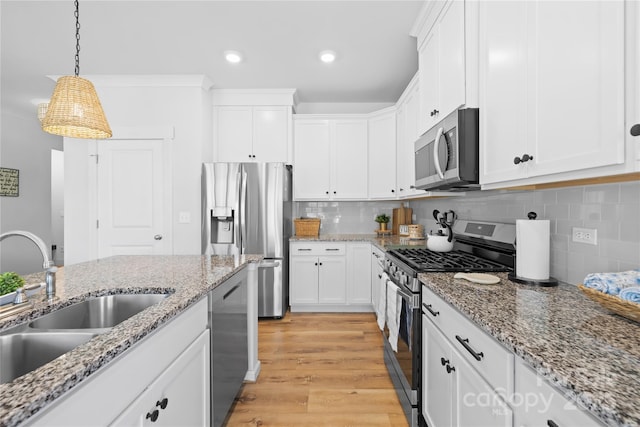 3610 Whitney Way Unit 2, Terrell, NC 28682 - kitchen with stainless steel appliances, white cabinets, recessed lighting, hanging light fixtures, and light wood finished floors
