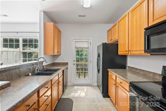 14664 Lions Paw St, Charlotte, NC 28273 - kitchen with black appliances, light tile patterned floors, and dark countertops