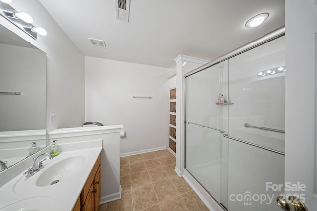 14664 Lions Paw St, Charlotte, NC 28273 - bathroom with double vanity, a stall shower, and tile patterned flooring