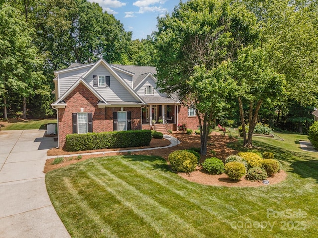 2804 Pulaski Dr, Monroe, NC 28110 - view of front of house featuring brick siding, a front lawn, and a porch