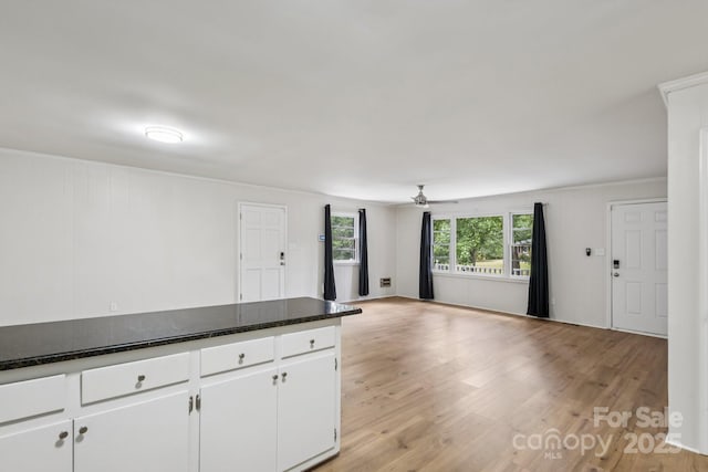 613 Davis St, Lancaster, SC 29720 - kitchen featuring white cabinetry, a ceiling fan, light wood-style floors, open floor plan, and dark stone counters