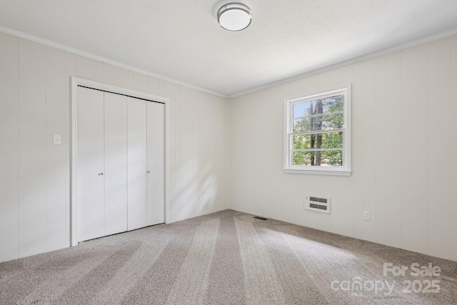 613 Davis St, Lancaster, SC 29720 - unfurnished bedroom with crown molding, carpet, a closet, and heating unit