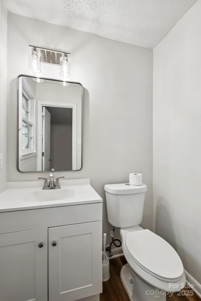 613 Davis St, Lancaster, SC 29720 - bathroom with a textured ceiling, vanity, and wood finished floors