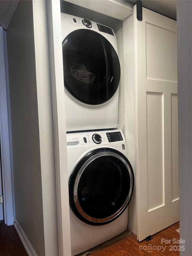 140 Lake Concord Rd NE, Concord, NC 28025 - laundry area with estacked washer and dryer and wood finished floors