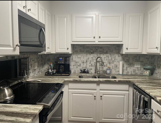 140 Lake Concord Rd NE, Concord, NC 28025 - kitchen featuring stainless steel appliances, white cabinetry, backsplash, and light stone countertops