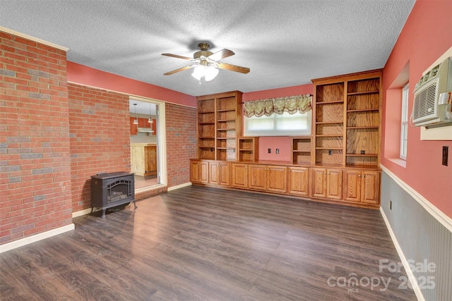 37156 Southside Rd, Albemarle, NC 28001 - unfurnished living room with a wood stove, healthy amount of natural light, a ceiling fan, dark wood finished floors, and a textured ceiling