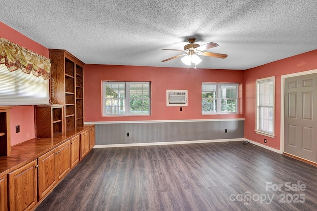 37156 Southside Rd, Albemarle, NC 28001 - unfurnished living room with a ceiling fan, dark wood finished floors, a textured ceiling, an AC wall unit, and plenty of natural light