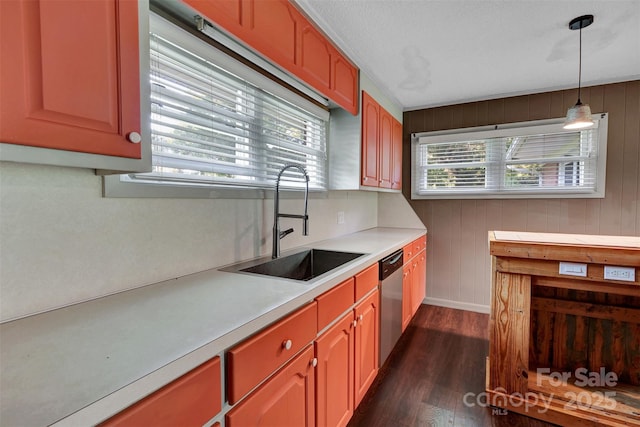 37156 Southside Rd, Albemarle, NC 28001 - kitchen with stainless steel dishwasher, dark wood finished floors, light countertops, hanging light fixtures, and wood walls