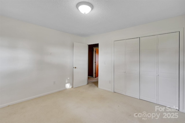 37156 Southside Rd, Albemarle, NC 28001 - unfurnished bedroom featuring light colored carpet, a closet, and a textured ceiling