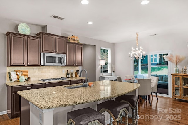 3701 Methodist Church Ln, Waxhaw, NC 28173 - kitchen with stainless steel appliances, dark brown cabinetry, tasteful backsplash, wood finished floors, and recessed lighting
